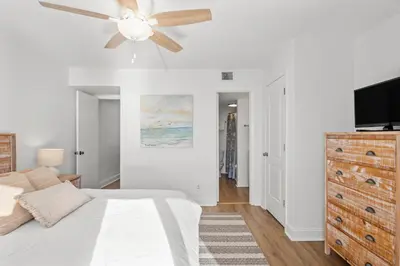 a bedroom with a bed and a ceiling fan at Pinnacle Port Penthouse 15 in Carillon Beach