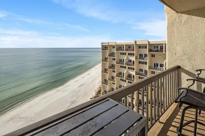 a balcony with a view of the beach and buildings at Pinnacle Port Penthouse 15 in Carillon Beach