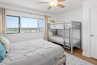 a bedroom with a bunk bed and a ceiling fan at Pinnacle Port Penthouse 15 in Carillon Beach