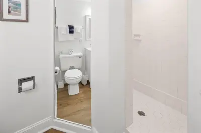 a white bathroom with a toilet and a shower at Pinnacle Port Penthouse 15 in Carillon Beach