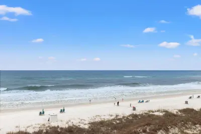 a group of people on a beach near the ocean at Pinnacle Port C1-401 in Carillon Beach
