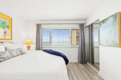 a bedroom with a bed and a window at Pinnacle Port C1-401 in Carillon Beach