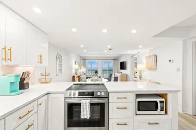 a kitchen with white cabinets and a stove at Pinnacle Port C1-401 in Carillon Beach