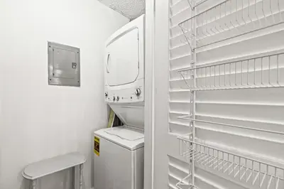 a white laundry room with a washer and dryer at Pinnacle Port C1-401 in Carillon Beach