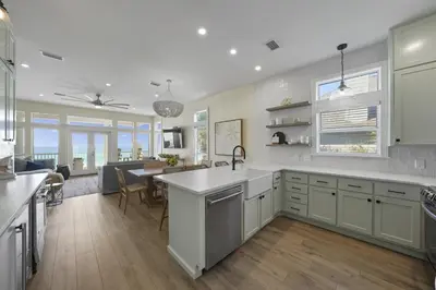 a kitchen and living room with a sink and a table at Rays on 30A in Santa Rosa Beach