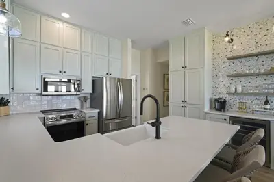 a kitchen with white cabinets and a white counter top at Rays on 30A in Santa Rosa Beach