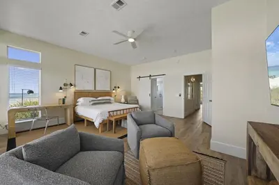 a living room with a bed and a couch and chairs at Rays on 30A in Santa Rosa Beach