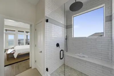 a white bathroom with a shower and a window at Rays on 30A in Santa Rosa Beach
