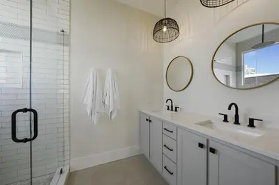 a white bathroom with a sink and a mirror at Rays on 30A in Santa Rosa Beach
