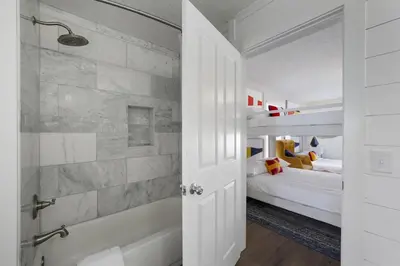 a bathroom with a shower and a bedroom with a bed at Rays on 30A in Santa Rosa Beach