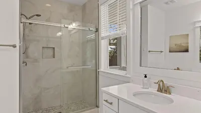 a white bathroom with a shower and a sink at Near Inlet Beach AccessLake Powell Pool Patio Lounge GDay 30A by AvantStay in Inlet Beach