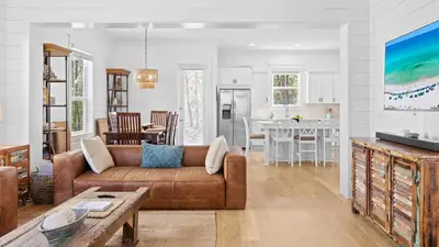 a living room with a couch and a kitchen at Near Inlet Beach AccessLake Powell Pool Patio Lounge GDay 30A by AvantStay in Inlet Beach