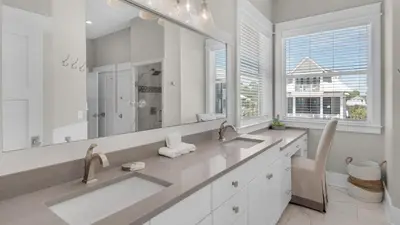 a bathroom with two sinks and a large mirror at The Bee's Knees in Santa Rosa Beach