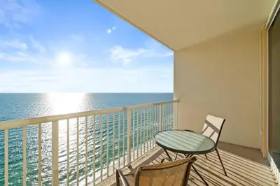 a balcony with a table and chairs and the ocean at Majestic Beach Resort Tower 2 Unit 2207 in Panama City Beach