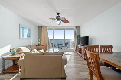 a living room with a couch and a table at Majestic Beach Resort Tower 2 Unit 2207 in Panama City Beach