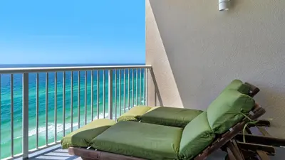 a balcony with a chaise lounge on the beach at Palazzo 806 in Panama City Beach
