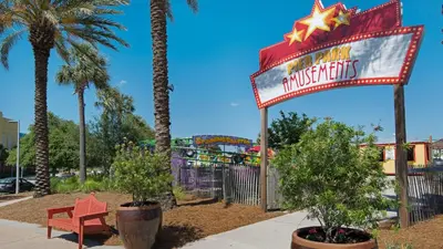 a sign at a amusement park with a roller coaster at Palazzo 806 in Panama City Beach