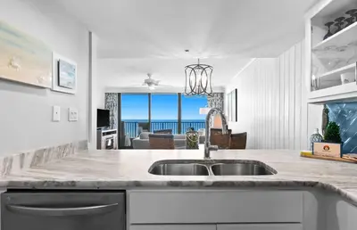 a kitchen with a sink and a view of the ocean at One Seagrove Place 1504 in Santa Rosa Beach