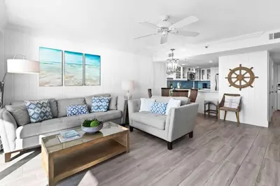 a living room with a couch and a table at One Seagrove Place 1504 in Santa Rosa Beach