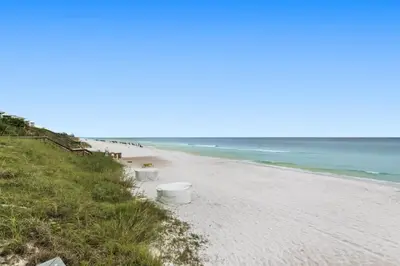 a beach with a row of white buckets on it at One Seagrove Place 1504 in Santa Rosa Beach