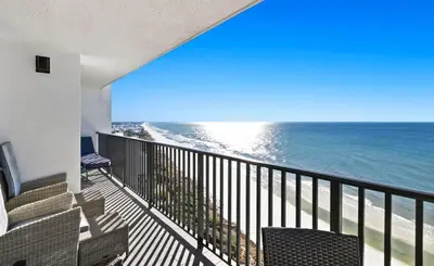 a balcony with chairs and a view of the ocean at One Seagrove Place 1504 in Santa Rosa Beach