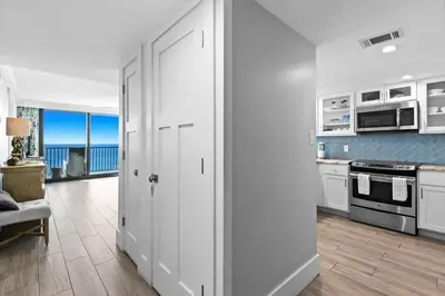 a kitchen with white cabinets and a view of the ocean at One Seagrove Place 1504 in Santa Rosa Beach