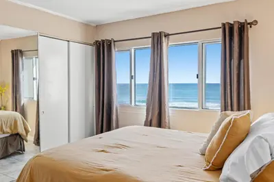 a bedroom with a bed and a view of the ocean at Pinnacle Port, C1-303 in Panama City Beach