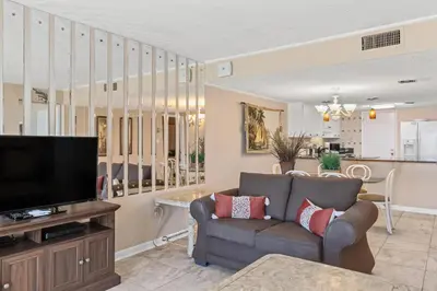 a living room with a couch and a television at Pinnacle Port, C1-303 in Panama City Beach