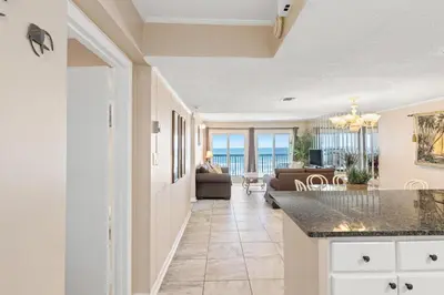 a kitchen and living room with a view of the ocean at Pinnacle Port, C1-303 in Panama City Beach