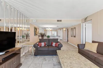 a living room with a couch and a television at Pinnacle Port, C1-303 in Panama City Beach