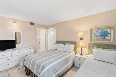a bedroom with a bed and a flat screen tv at Pinnacle Port, C1-303 in Panama City Beach