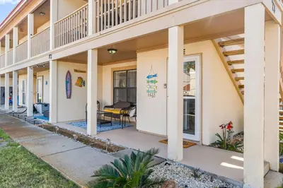 a house with a porch and a balcony at Condo w/beach, pools, tennis, shuffleboard, more! in Panama City Beach
