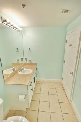 a bathroom with a sink and a mirror at Lake Town Charming Condo Steps from the Beach in Panama City Beach