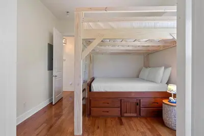 a bedroom with a bunk bed with a wooden dresser at Ocean Glory 30A in Inlet Beach
