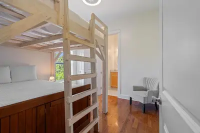 a bedroom with a bunk bed and a chair at Ocean Glory 30A in Inlet Beach