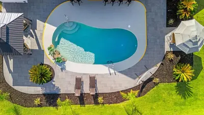 an overhead view of a swimming pool in a house at PCB Group-Friendly Duplex w Pool Backyard Lounge 2 Kitchens in Panama City Beach