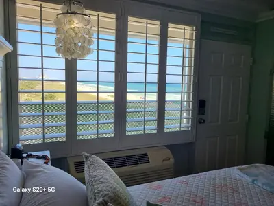 a bedroom with a bed and a view of the ocean at Fontainebleau Terrace #430 in Panama City Beach