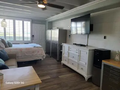 a living room with a bed and a room with a kitchen at Fontainebleau Terrace #430 in Panama City Beach