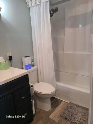 a bathroom with a white toilet and a shower at Fontainebleau Terrace #430 in Panama City Beach