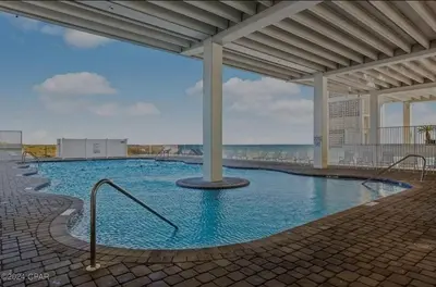 a swimming pool with blue water in a building at Fontainebleau Terrace #430 in Panama City Beach
