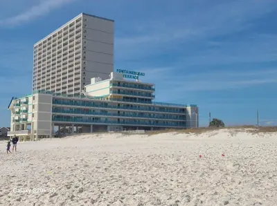 a building on the beach next to a sandy beach at Fontainebleau Terrace #430 in Panama City Beach
