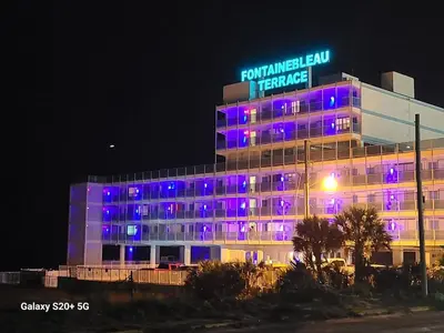 a building with purple lights on the side of it at Fontainebleau Terrace #430 in Panama City Beach