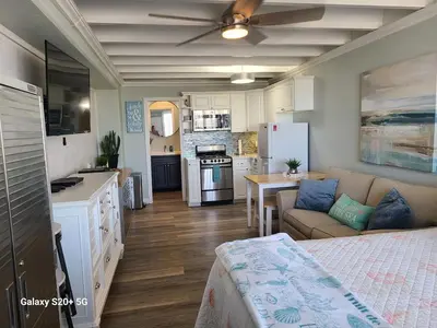 a kitchen and living room with a bed and a couch at Fontainebleau Terrace #430 in Panama City Beach