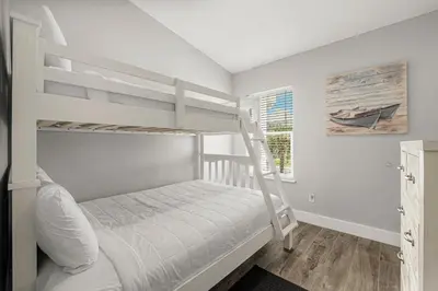 a bedroom with two bunk beds and a window at Beachside West Villa #2 by Emerald Coast Retreats in Panama City Beach