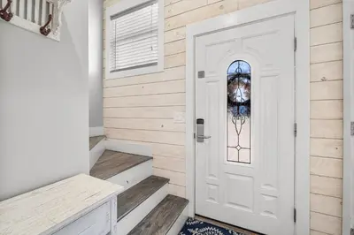 a white door with a stained glass window at Beachside West Villa #2 by Emerald Coast Retreats in Panama City Beach