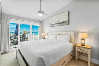a bedroom with a bed with a view of the ocean at Beachside West Villa #2 by Emerald Coast Retreats in Panama City Beach