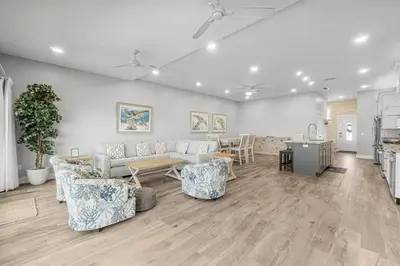 a living room with a couch and chairs and a table at Beachside West Villa #2 by Emerald Coast Retreats in Panama City Beach