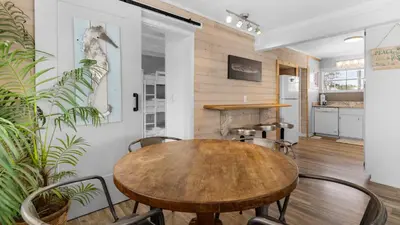 a dining room with a wooden table and chairs at Coastal Charm in Santa Rosa Beach