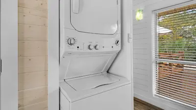 a white washer and dryer in a kitchen with a window at Coastal Charm in Santa Rosa Beach