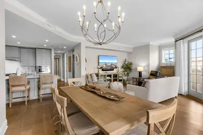 a dining room and living room with a dining table at Casa Del Oro Penthouse at Barrett Square - Downtown Rosemary Beach Pool &Hot Tub Access in Rosemary Beach